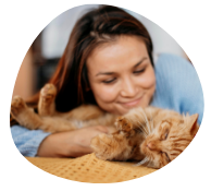 A smiling cat parent with sleeping brown cat that are happy with Pawland's petcare and sitting services which are provided at home