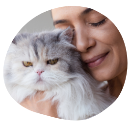 A white cat with a happy cat sitter who is giving the care to the cat through Pawland’s trusted pet sitting services