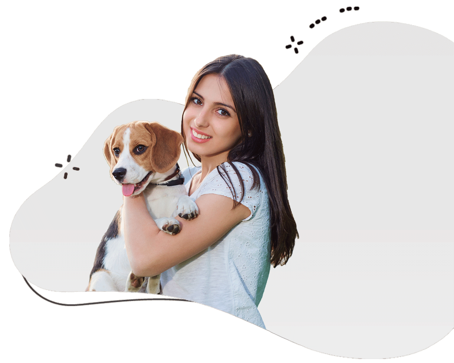 Loving female dog sitter wearing a grey shirt with brown hair holding a beagle in her arms and providing services in the UAE