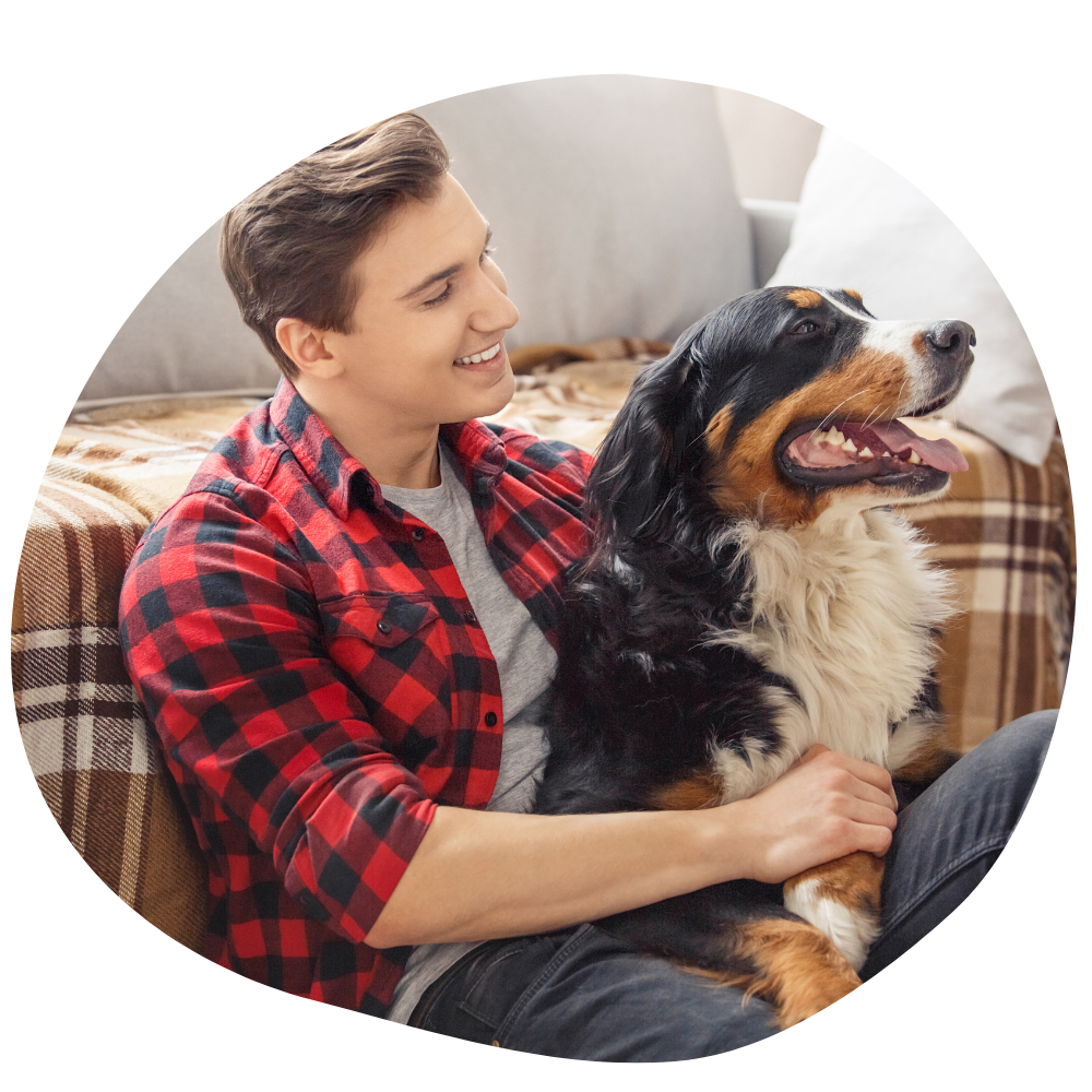 Dog parent wearing a red flannel that has availed Pawland pet sitting services in Dubai
