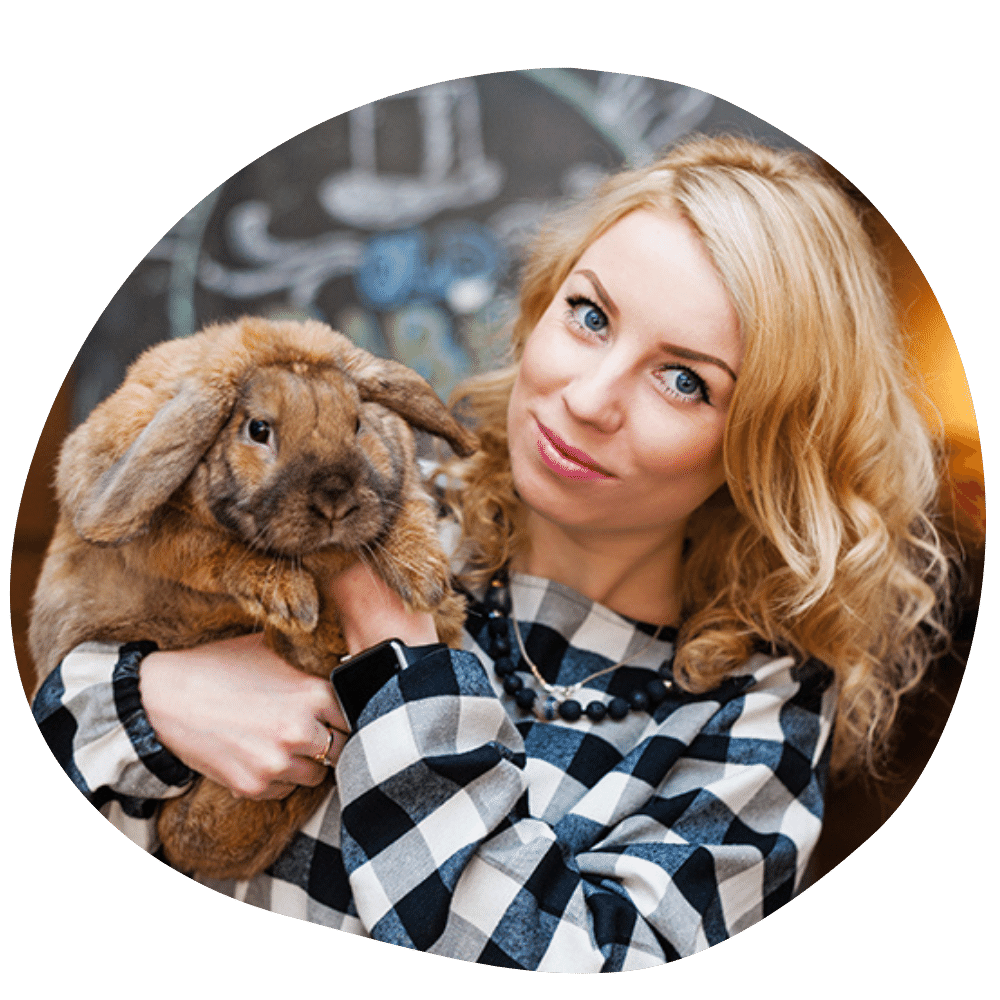 Happy rabbit parent wearing plaid shirt holding fluffy brown rabbit after Pawland’s rabbit sitting & boar