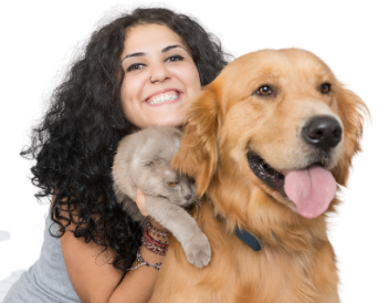 Dog owner happily holding a yellow dog in their arms