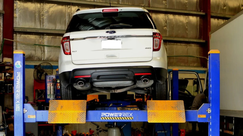 PLATINUM Auto Service Center Dubai with a whtie car