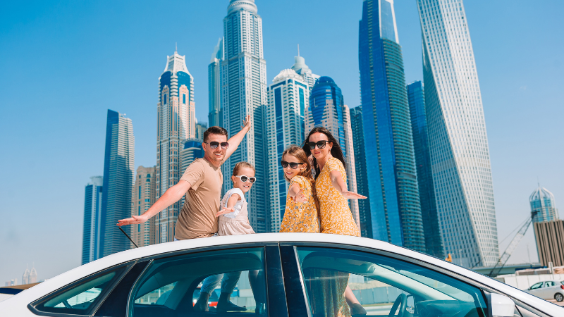 a cute family on the car in dubai marina city