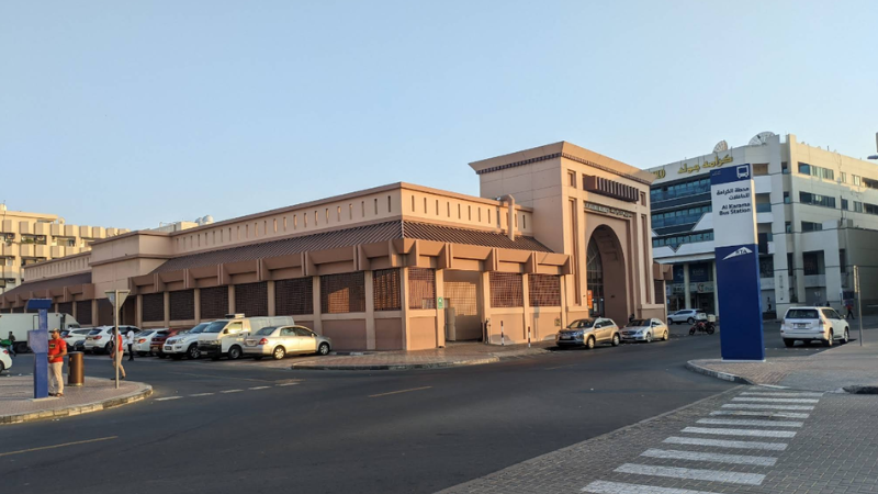 Al Karama Market Dubai full view with main entrance gate and busy main road with shops and city traffic in Dubai UAE