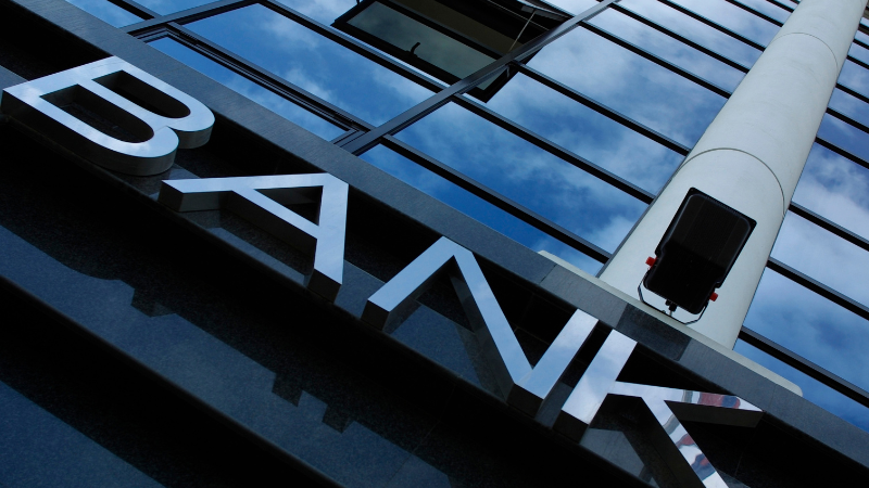 Full building view of a bank in Al Karama Dubai with modern architecture and busy street surroundings in the city