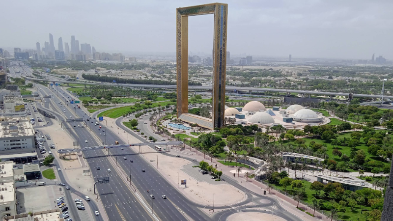 Al Karama Dubai full view with busy main road, residential buildings, shops, and urban city life in Dubai UAE