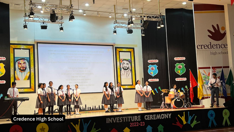Students performing on stage during a school function in the auditorium at Credence High School