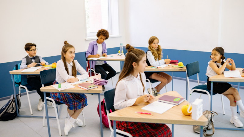 Students attending a classroom lesson in Dubai, sitting attentively and participating in an interactive class session in a modern educational environment