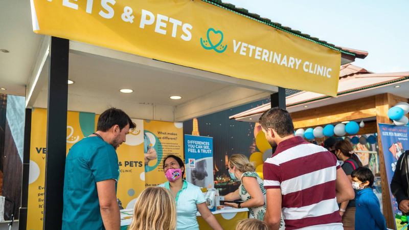 VETS & PETS shop interior with staff providing professional pet care services to customers in a clean and organized environment