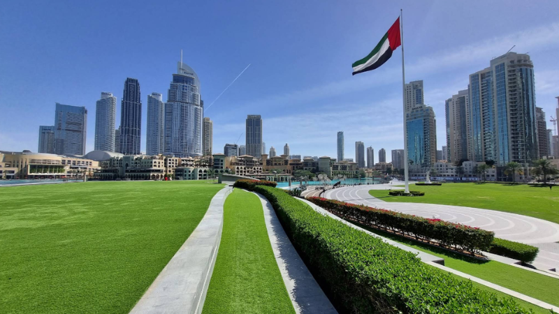 Burj Park dubai full view with uae national flag