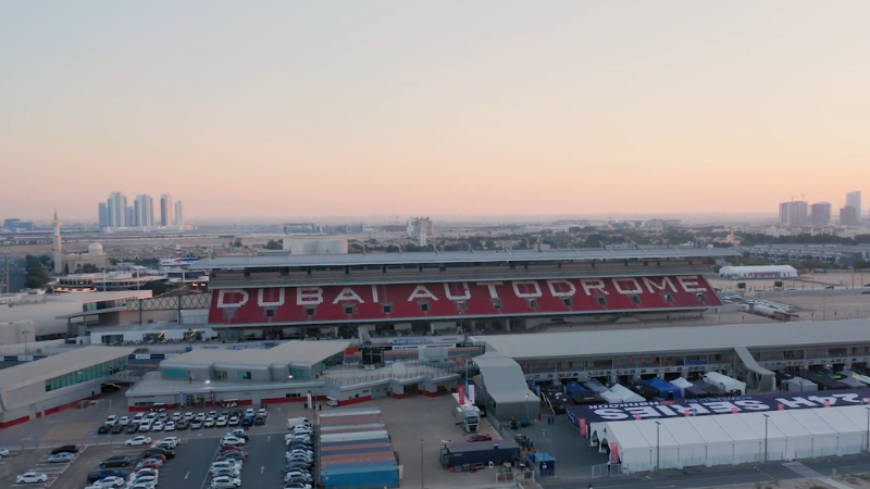 Full view of Dubai Autodrome showing main gate entrance and parking area, a popular motorsport destination in Dubai