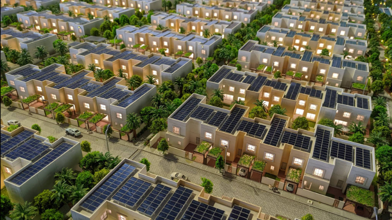 3D aerial view of The Sustainable City Dubai showing green spaces, modern eco-friendly buildings, and solar panels, highlighting sustainable urban living.