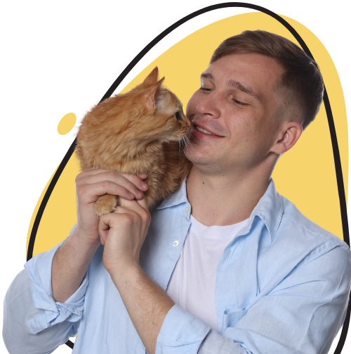 Young cat sitter in Dubai cuddling a cat on his shoulder with a soft yellow background.