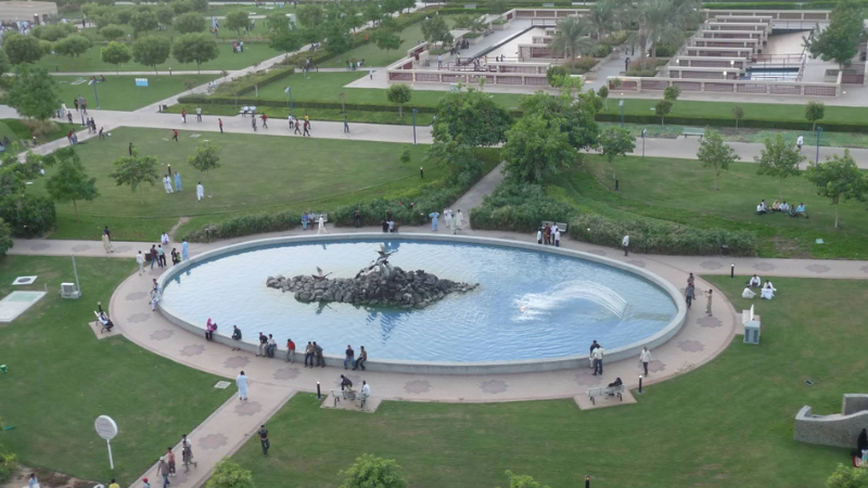 Farmer Park full view with people walking, exploring pathways, and visiting attractions in a lively outdoor setting