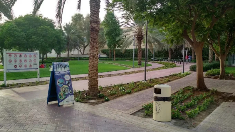 Interior view of Mirdif Park featuring shaded seating areas and landscaped pathways.