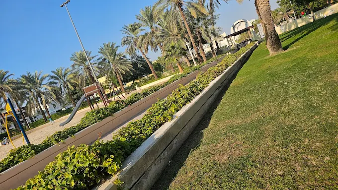 Scenic view inside Al Wasl Park in Dubai with green lawns and walking paths