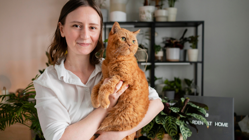 Lady cat owner holding her domestic cat with love and care
