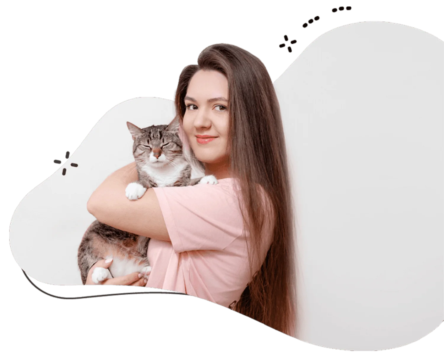 Female cat sitter in a pink tee shirt holding a British longhair cat in her arms who provides cat sitting services