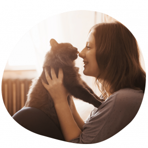 Cat parent holding her cat wearing a grey tee shirt after booking pet sitting services in Sharjah Cat parent holding her cat wearing a grey tee shirt after booking pet sitting services in Sharjah