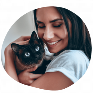 Cat parent wearing a white tee shirt holding a cat after booking Pawland’s cat sitter in Dubai Cat parent wearing a white tee shirt holding a cat after booking Pawland’s cat sitter in Dubai