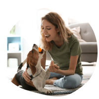 Happy female dog parent wearing grey t-shirt with dog after dog sitting services in Dubai