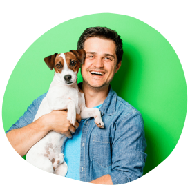 Male dog parent wearing Dubai availing dog sitting services for his white dog with white patches around e